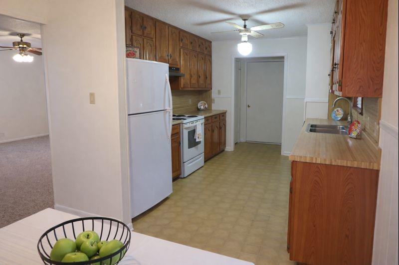 543 County Road 2940 Alba, TX 75410 - Photo 4 of 15 a kitchen with a refrigerator and a stove