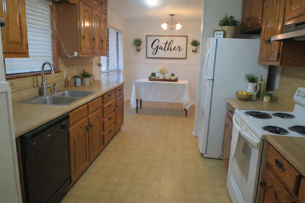 543 County Road 2940 Alba, TX 75410 - Photo 6 of 15 a kitchen with stainless steel appliances a refrigerator a sink a stove and white cabinets