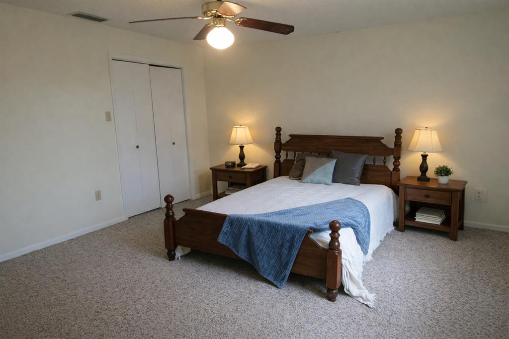 543 County Road 2940 Alba, TX 75410 - Photo 10 of 15 a bedroom with a bed and a lamp