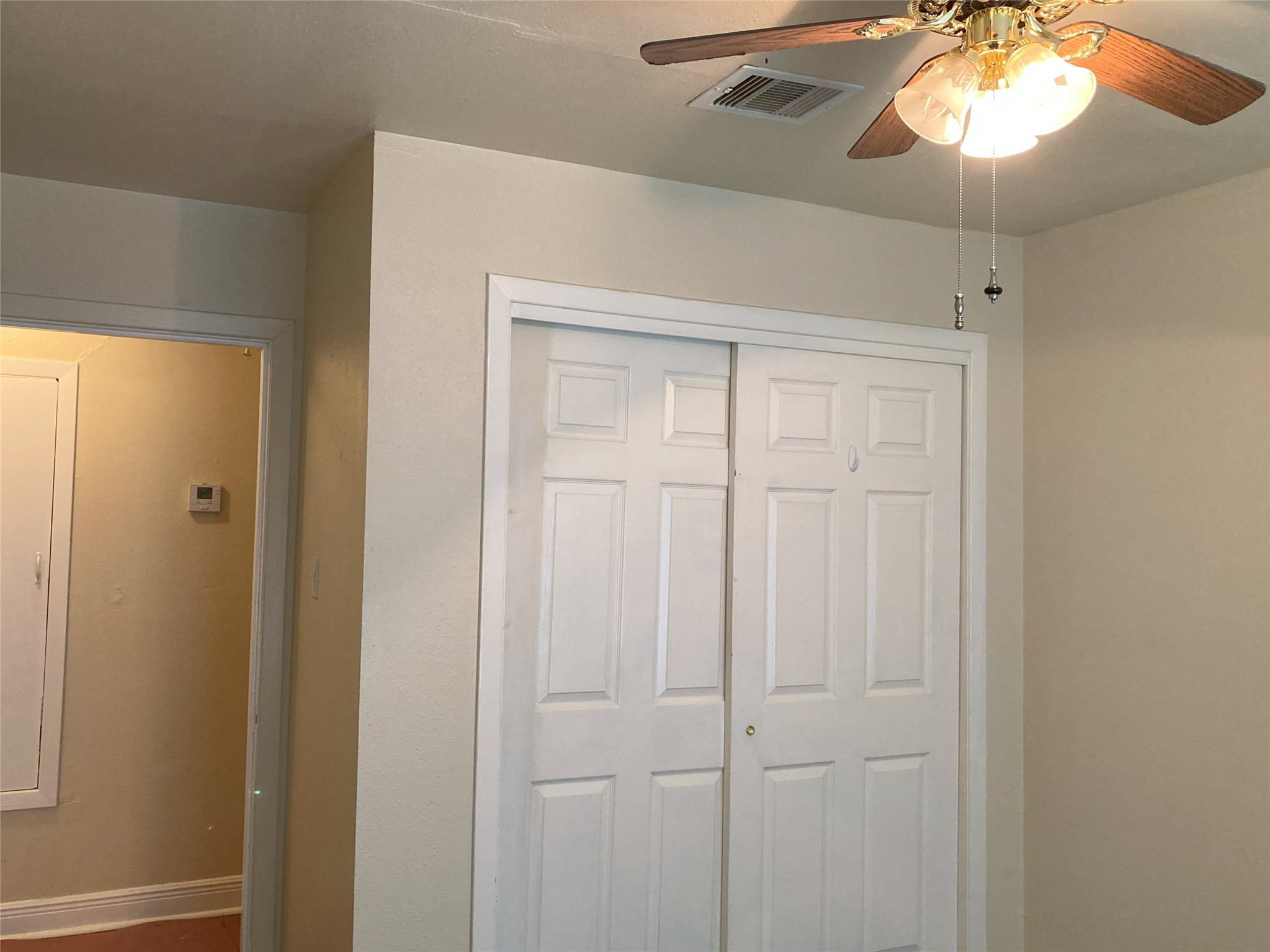 1202 Dunstan Road Pasadena, TX 77502 - Photo 16 of 24 First bedroom down the hall on the left with fresh paint, ceiling fan, and hardwoods.