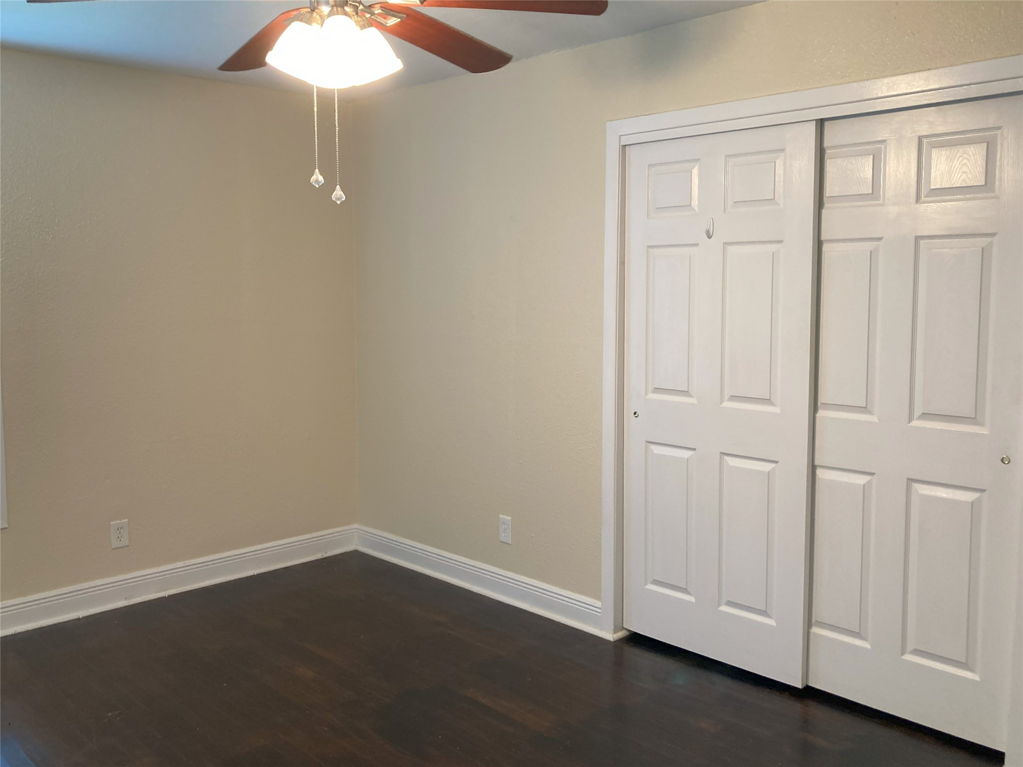 1202 Dunstan Road Pasadena, TX 77502 - Photo 19 of 24 Second bedroom at the back left with hardwoods, fresh paint, and ceiling fan.