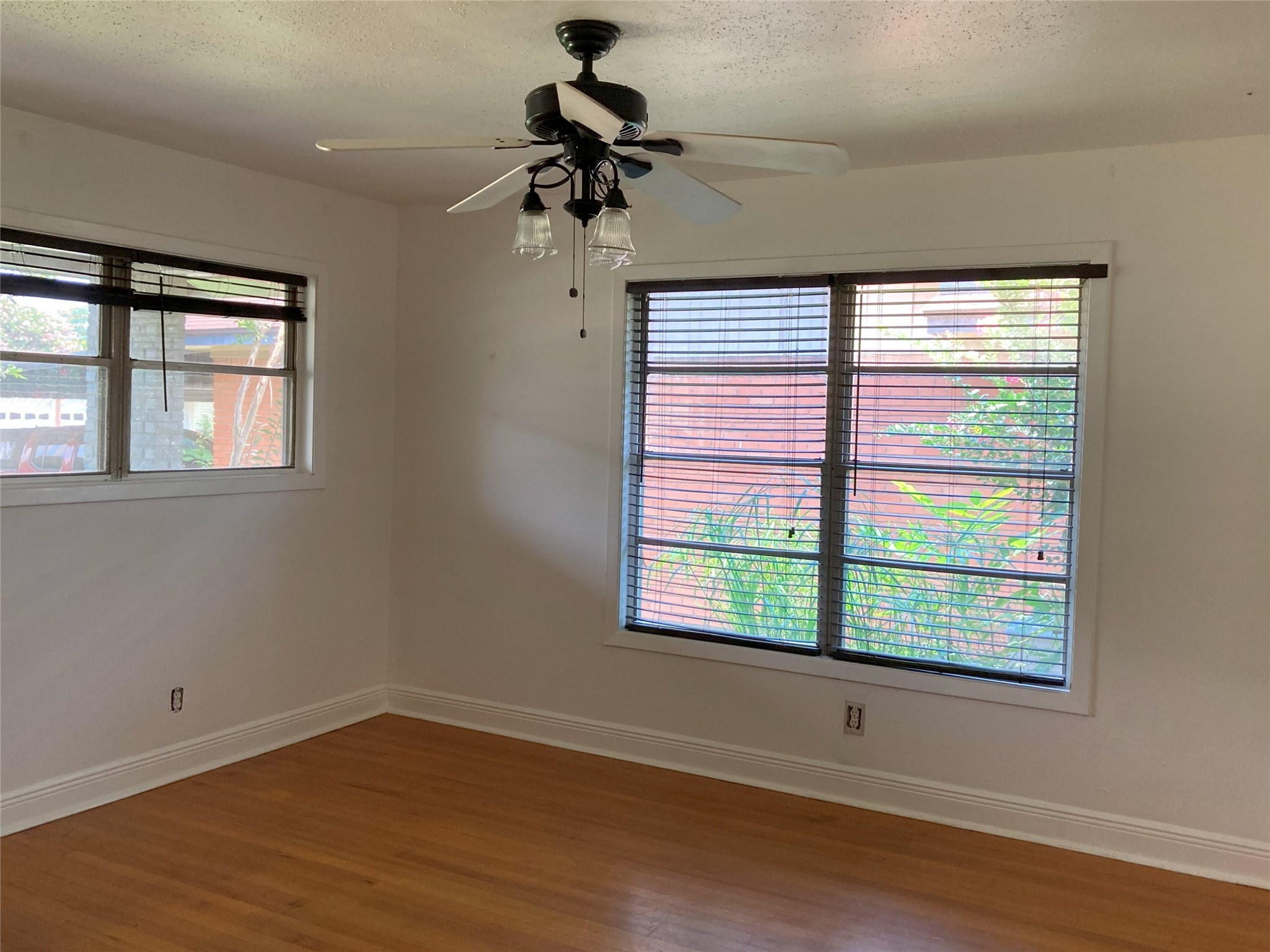 1202 Dunstan Road Pasadena, TX 77502 - Photo 6 of 24 Living room with beautiful original hardwood floors and plenty of natural light
