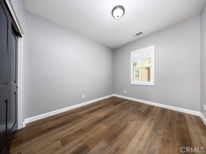 2999 Walking Beam Place Brea, CA 92821 - Photo 13 of 26 an empty room with wooden floor and windows