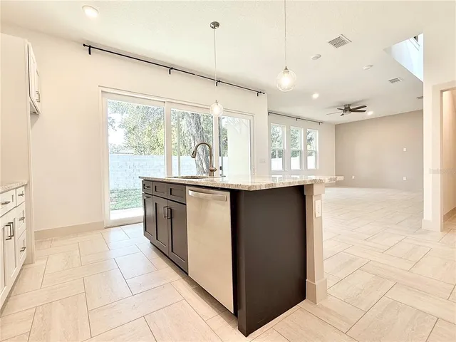 a kitchen with stainless steel appliances granite countertop a sink and a counter space