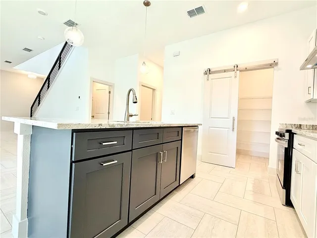 a bathroom with a granite countertop sink a mirror and shower