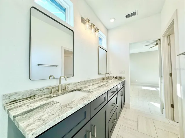 a bedroom with bed and a large window