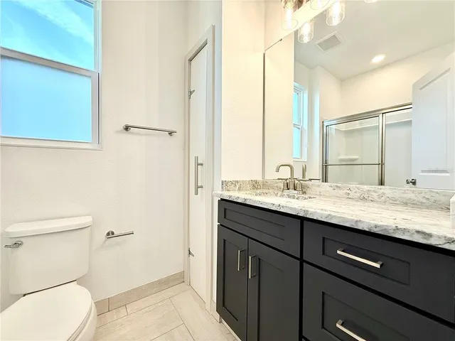 a bedroom with bed and a couch