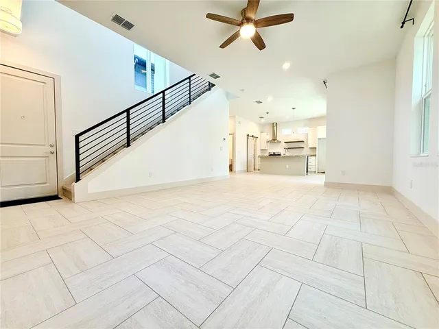 a view of a kitchen with furniture and a ceiling fan