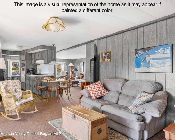 a living room with furniture and kitchen view
