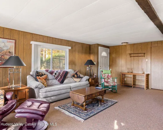 a living room with furniture and a lamp