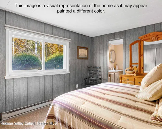 a view of a bedroom with a large bed and wooden floor