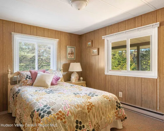 a bed sitting in a bedroom next to a window