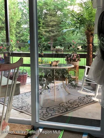 a view of a kitchen with stainless steel appliances wooden floor and a refrigerator
