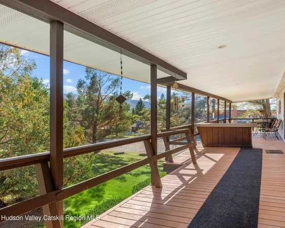 a balcony with wooden floor and outdoor space