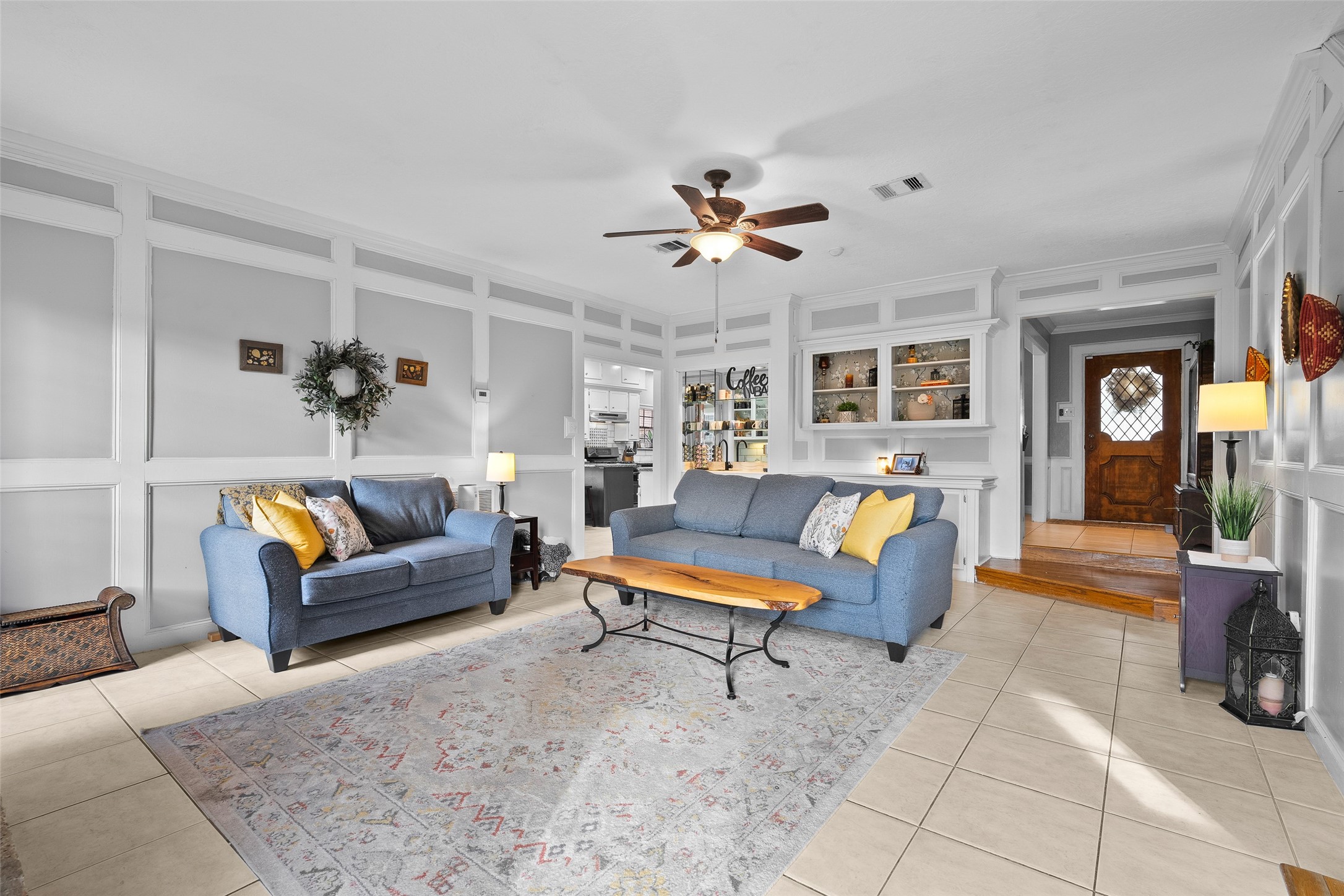 41 Windsor Drive Conroe, TX 77304 - Photo 8 of 39 The main living area opens with tile flooring, crown molding, and detailed wall trim that add character and warmth. This space offers a comfortable layout for everyday living while connecting easily to the entry and adjacent rooms.
