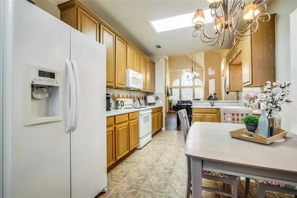 a kitchen with stainless steel appliances granite countertop a sink a stove and refrigerator