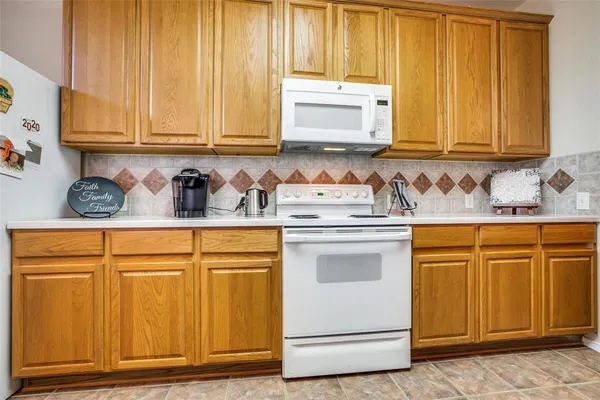 a kitchen with stainless steel appliances granite countertop cabinets and window