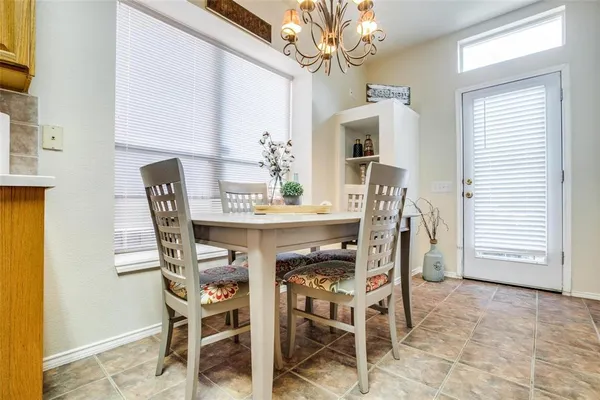 a view of a dining room with furniture and a chandelier