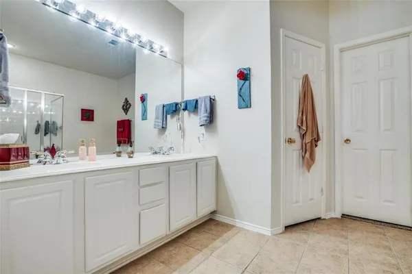 a bathroom with a mirror sink and shower