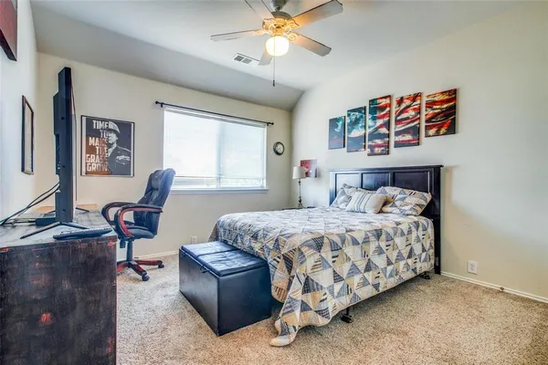 a bedroom with a bed and a chandelier