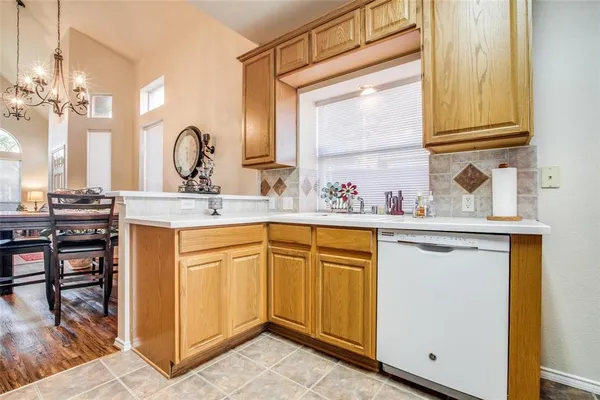 a kitchen with stainless steel appliances granite countertop a sink dishwasher stove and cabinets