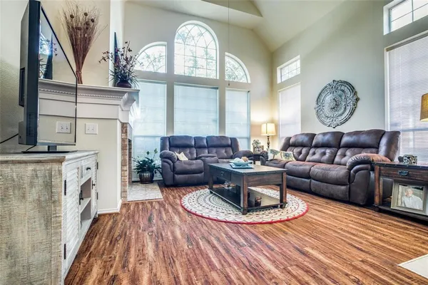 a living room with furniture a fireplace and a large window
