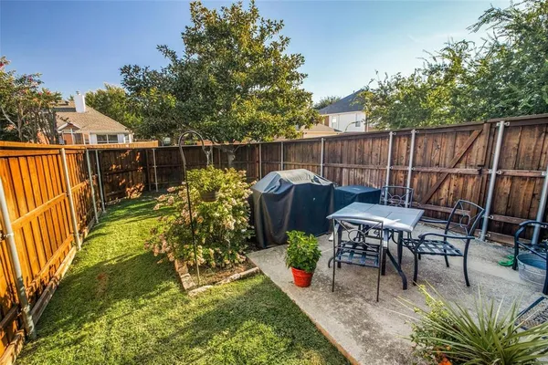 a view of a chairs and table in the patio