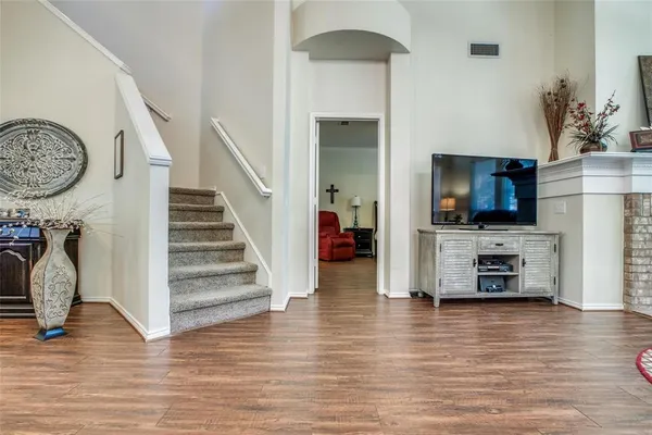 a view of a living room with furniture and a flat screen tv