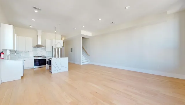 a view of kitchen and kitchen with a sink