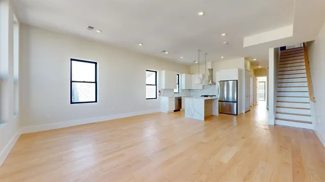 a view of kitchen with stainless steel appliances refrigerator and window
