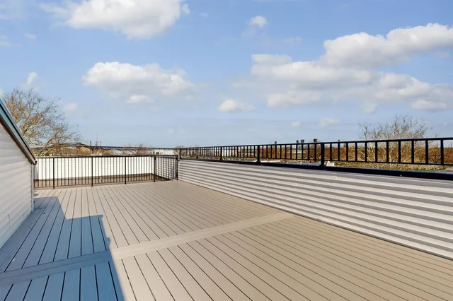 a view of balcony with wooden floor
