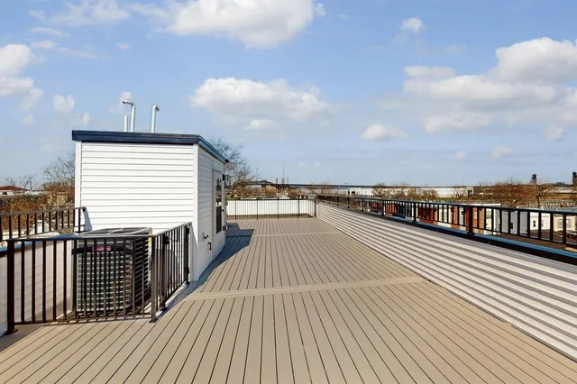 a kitchen with stainless steel appliances granite countertop a stove a sink and a refrigerator with wooden floor