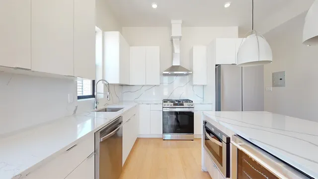 a view of a room with wooden floor and window