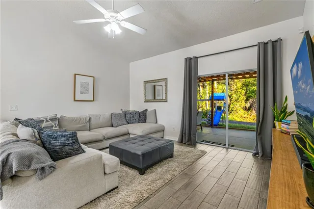 a living room with furniture a large window and a flat screen tv