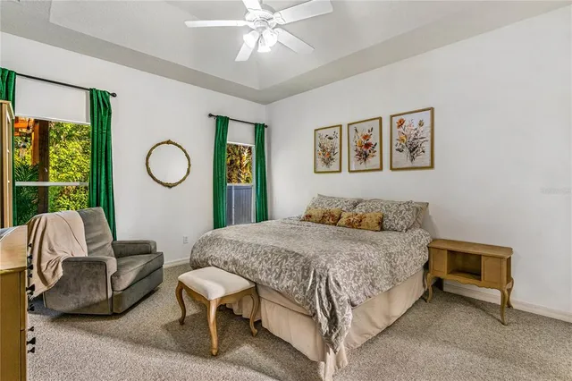 a bedroom with a bed a window and dresser