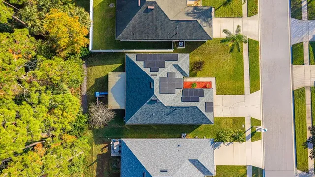 a view of a house with fountain and plants
