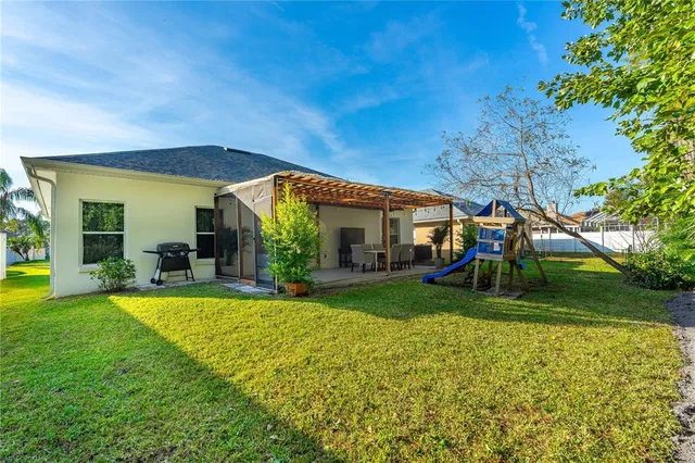 a view of a chair and table in backyard of the house