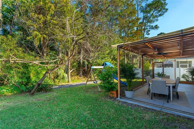 a view of a patio with a table and chairs under an umbrella