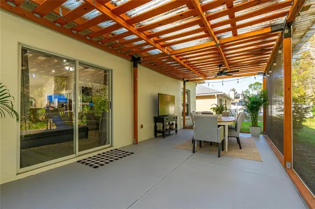 a view of patio with table and chairs and potted plants