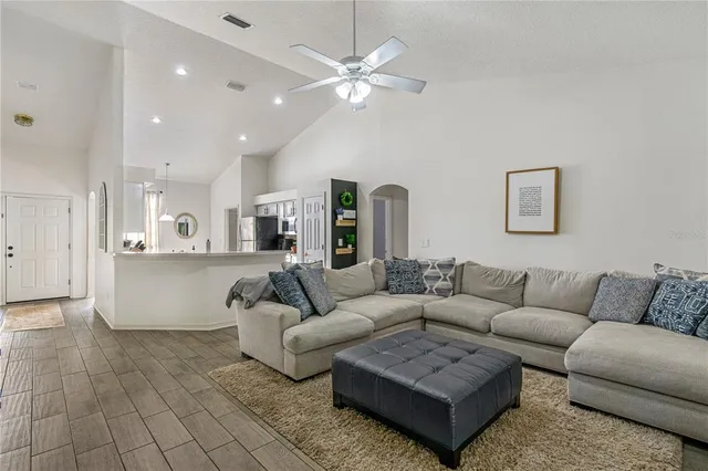 a living room with stainless steel appliances granite countertop furniture and a kitchen view