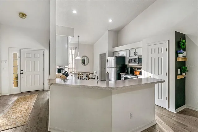 a kitchen with stainless steel appliances a refrigerator stove and microwave