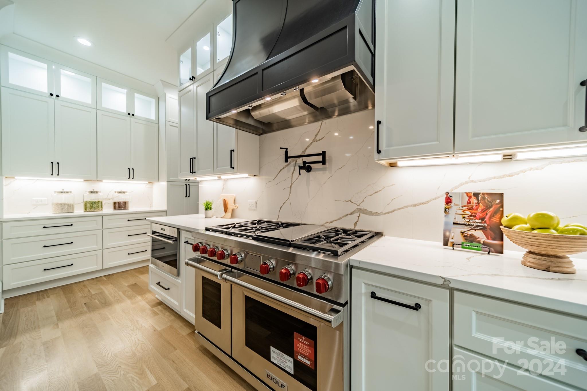 4428 Carmel Road Charlotte, NC 28226 - Photo 14 of 48 a kitchen with stainless steel appliances granite countertop a stove and a sink with cabinets
