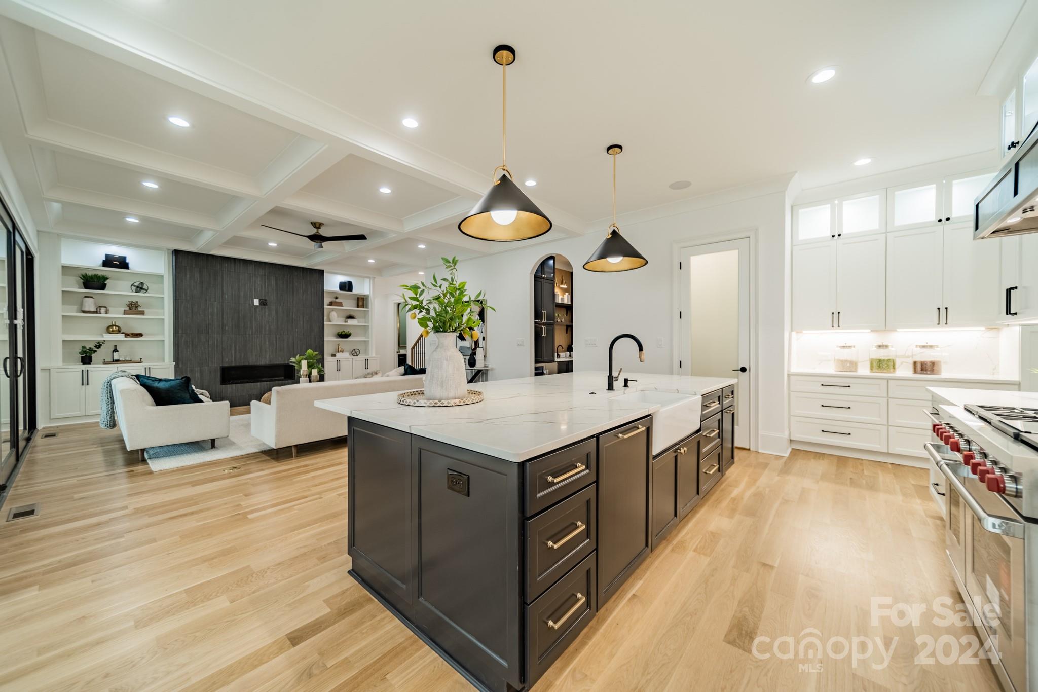 4428 Carmel Road Charlotte, NC 28226 - Photo 16 of 48 a large kitchen with stainless steel appliances a stove a sink dishwasher and a dining table with wooden floor