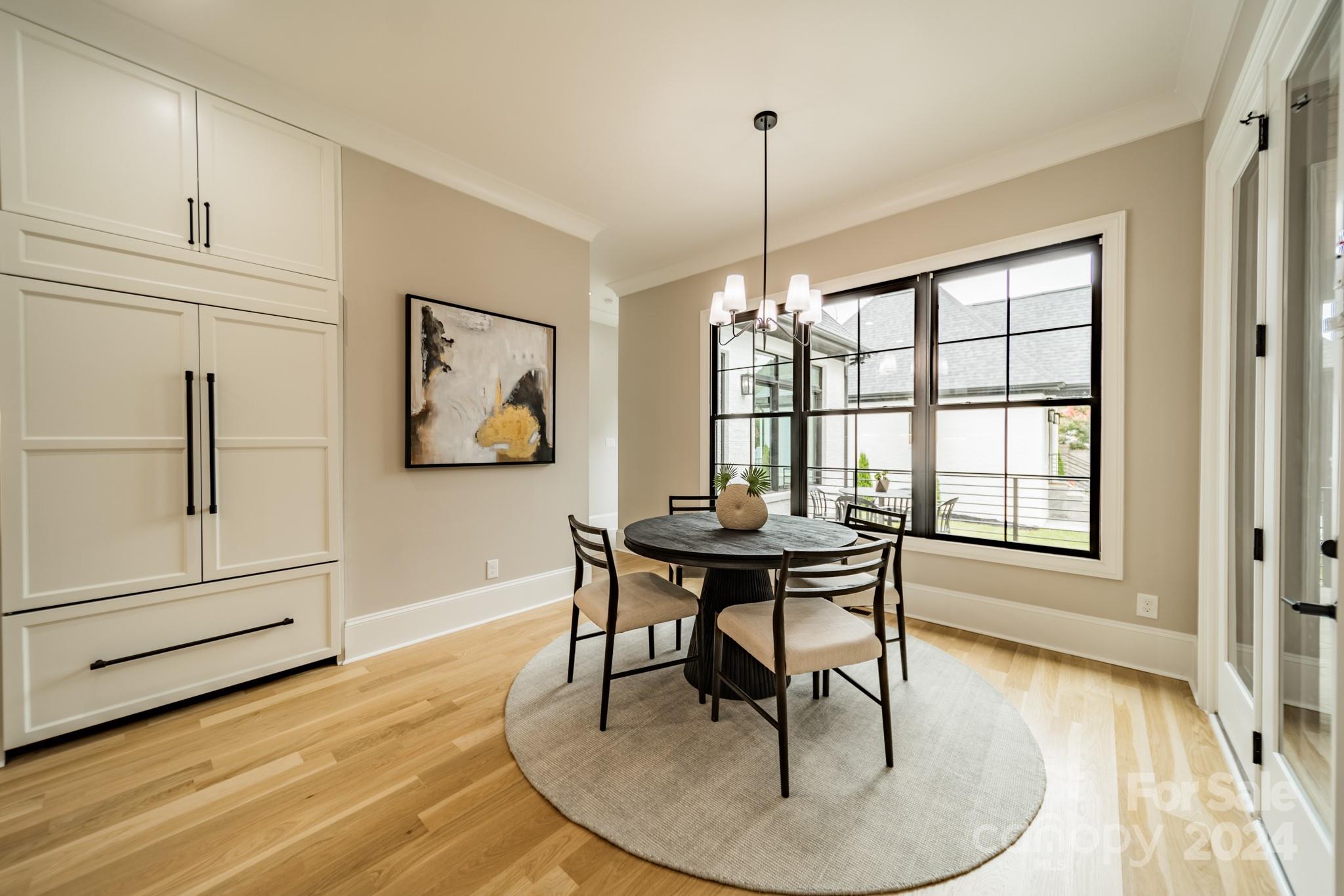 4428 Carmel Road Charlotte, NC 28226 - Photo 17 of 48 a dining room with chandelier and wooden floor