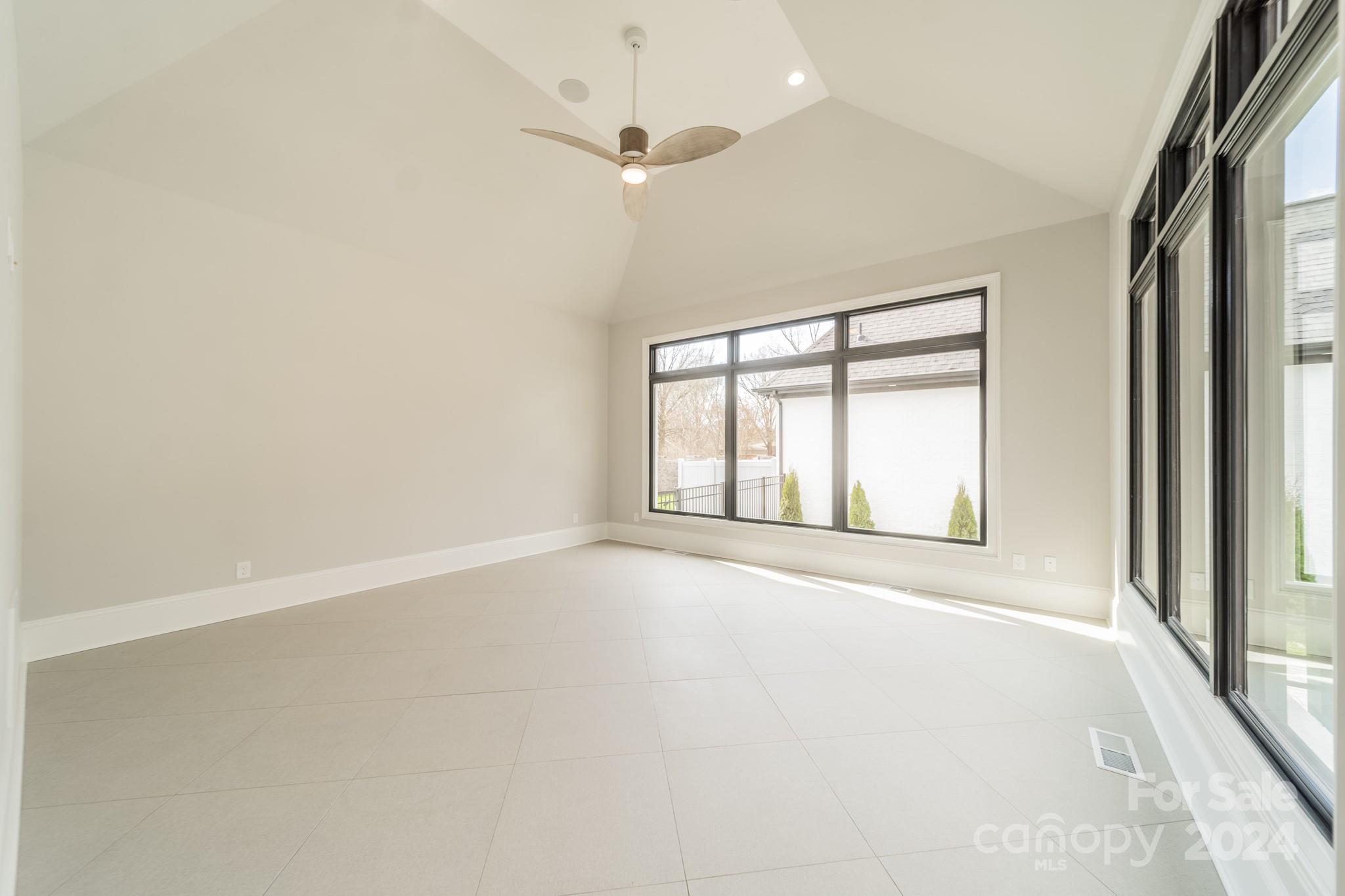 4428 Carmel Road Charlotte, NC 28226 - Photo 25 of 48 an empty room with a window and a ceiling fan