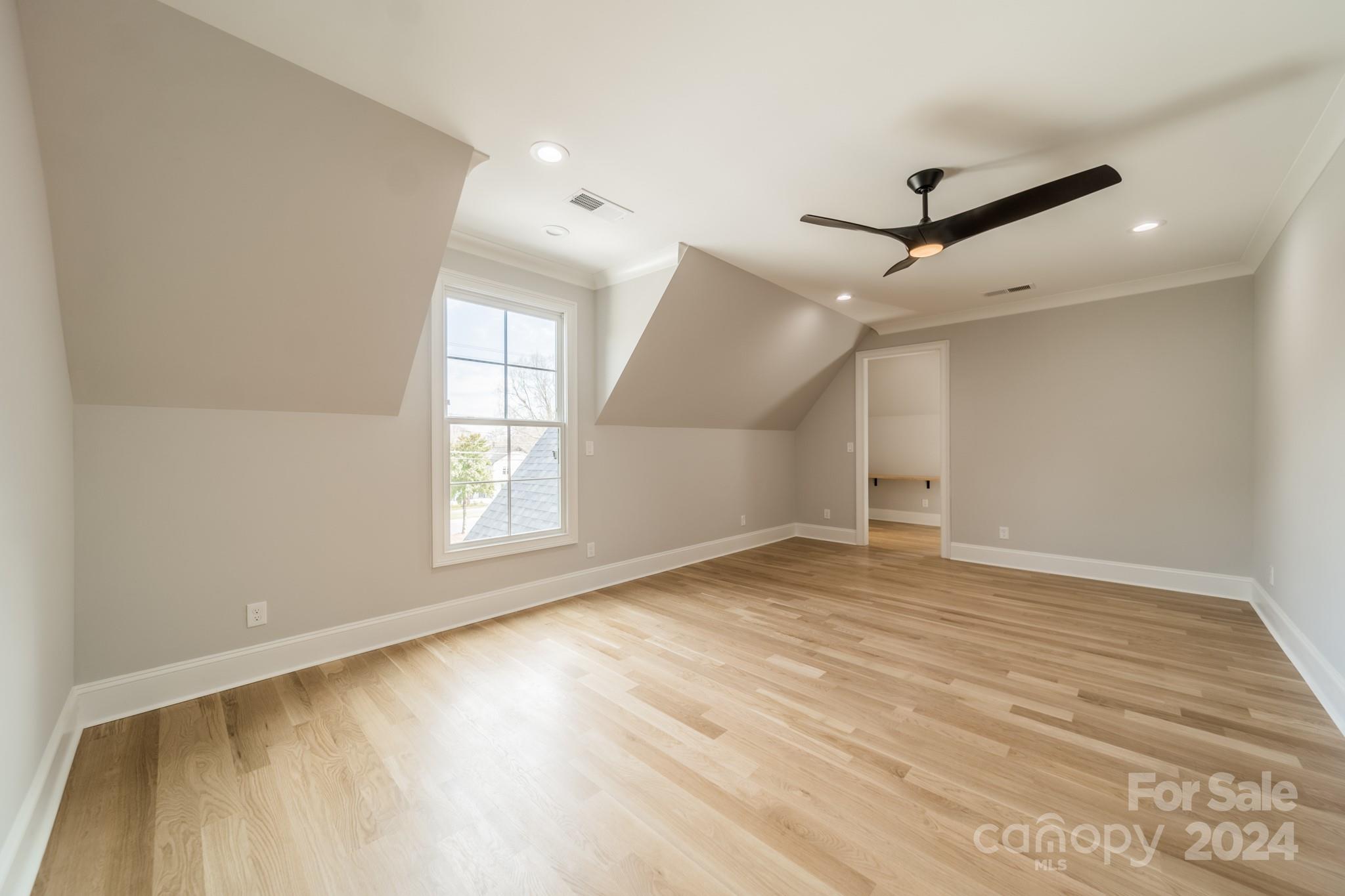 4428 Carmel Road Charlotte, NC 28226 - Photo 35 of 48 a view of empty room with wooden floor and fan