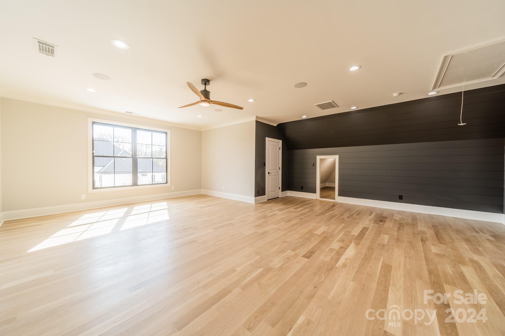 4428 Carmel Road Charlotte, NC 28226 - Photo 38 of 48 a view of an empty room with wooden floor and a window