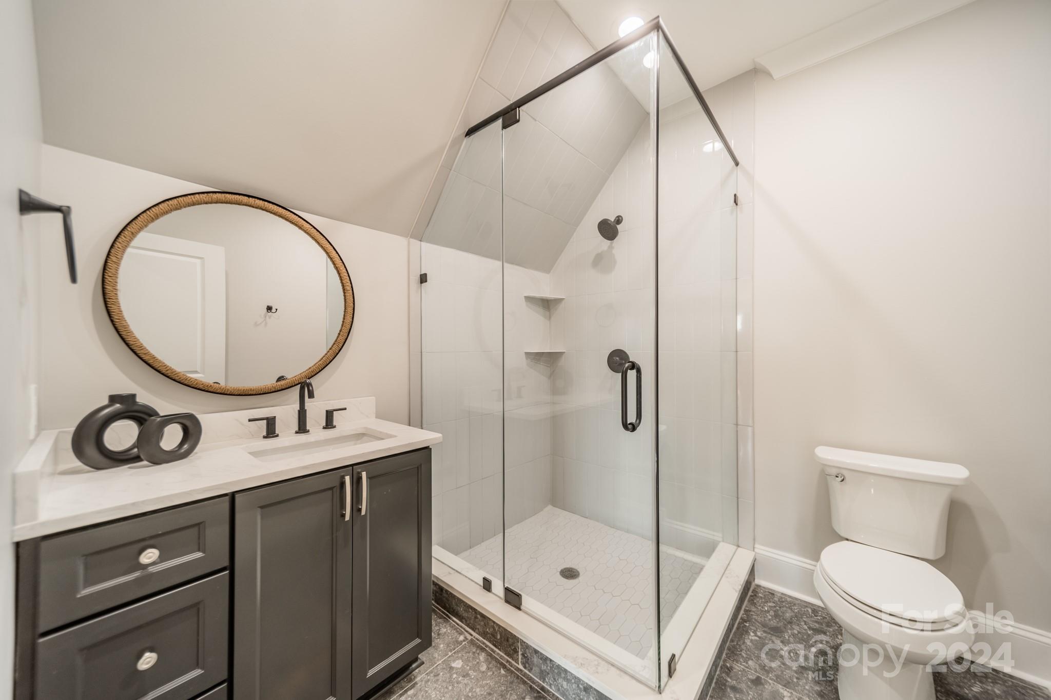 4428 Carmel Road Charlotte, NC 28226 - Photo 39 of 48 a bathroom with a sink a toilet and a mirror