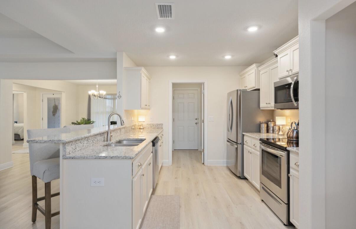 2191 Jernigan Drive Crestview, FL 32536 - Photo 14 of 42 a kitchen with stainless steel appliances granite countertop a sink stove and refrigerator
