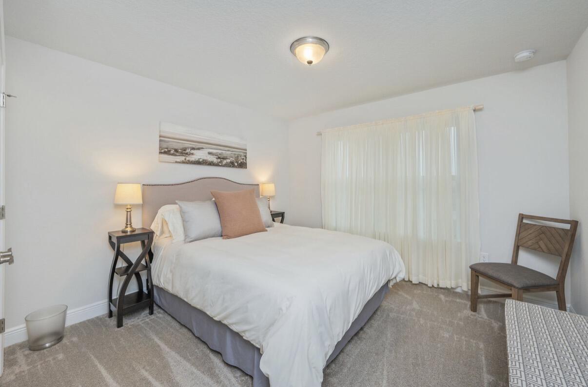 2191 Jernigan Drive Crestview, FL 32536 - Photo 25 of 42 a bedroom with a bed and chair